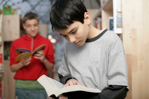 Young Boys Reading Books in the Library 