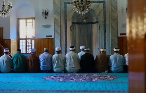 Free Group of men praying inside a traditional mosque in Istanbul, showcasing Islamic architecture. Stock Photo