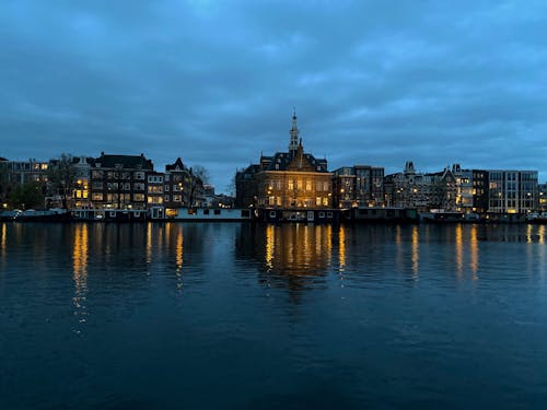 Illuminated Buildings in Amsterdam with the View of the Pestana Amsterdam Riverside Hotel 