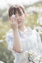 Woman Holding White Cherry Blossom Flower