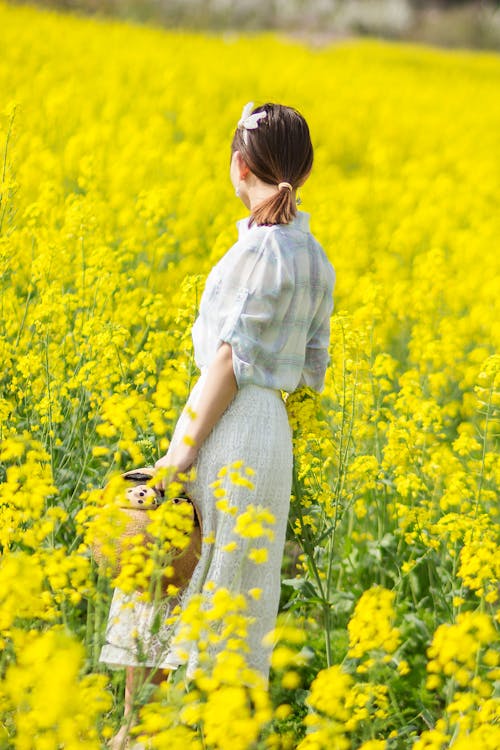 Woman Standing in Flower Field