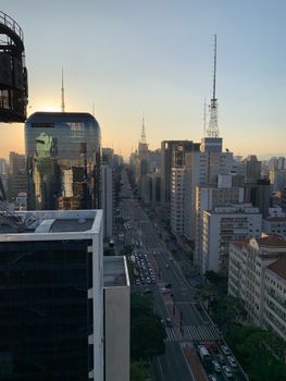 Stunning aerial cityscape of Sao Paulo, Brazil, showcasing skyscrapers and urban streets at dusk.