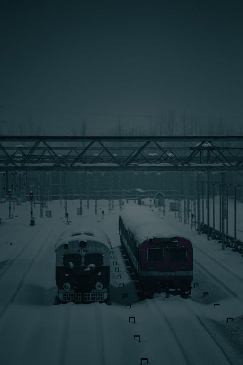 Free Snow-covered trains in a wintery urban setting at Mirgund station. Stock Photo