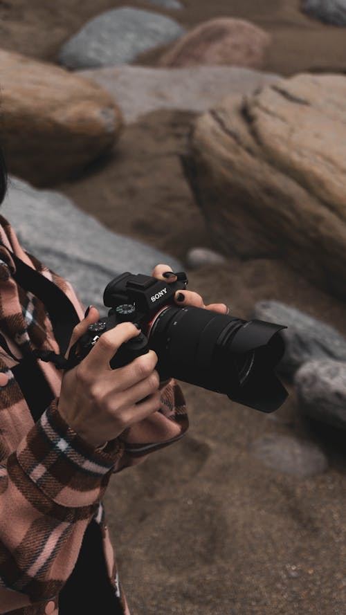 Person Holding a Black Camera