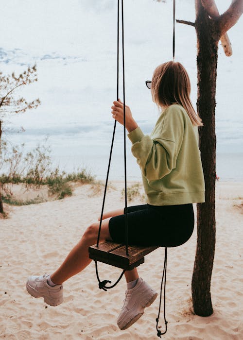 A Woman Sitting on the Swing 