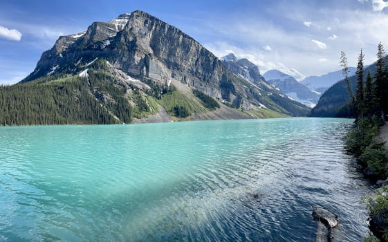 Serene view of Lake Louise with turquoise waters and the Canadian Rockies.