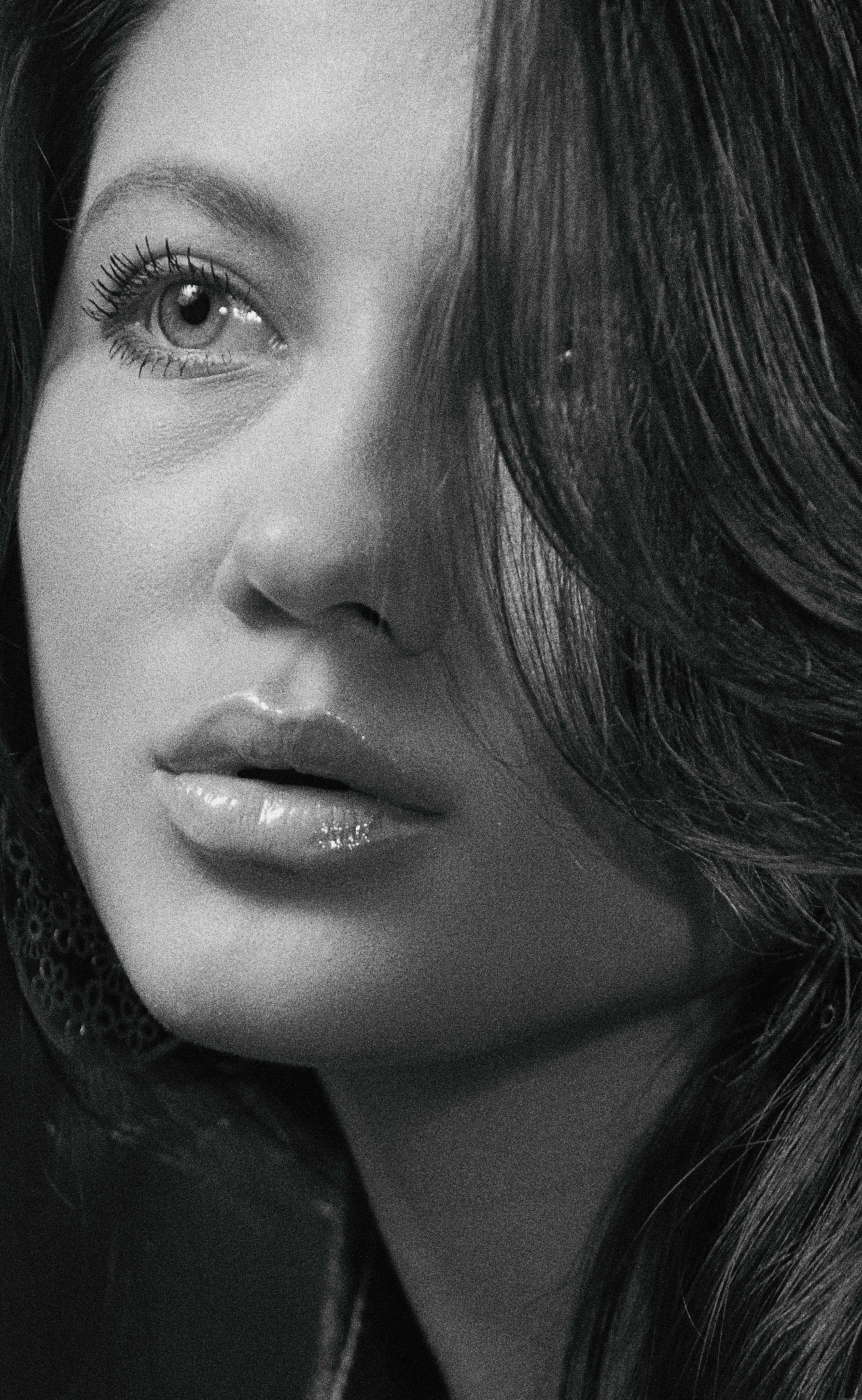 Close-up black and white portrait of a woman with an expressive gaze.