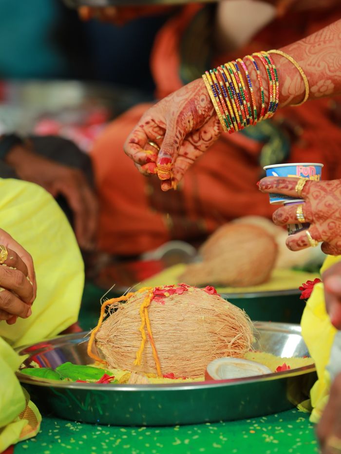 Henna-adorned hands during a haldi ceremony