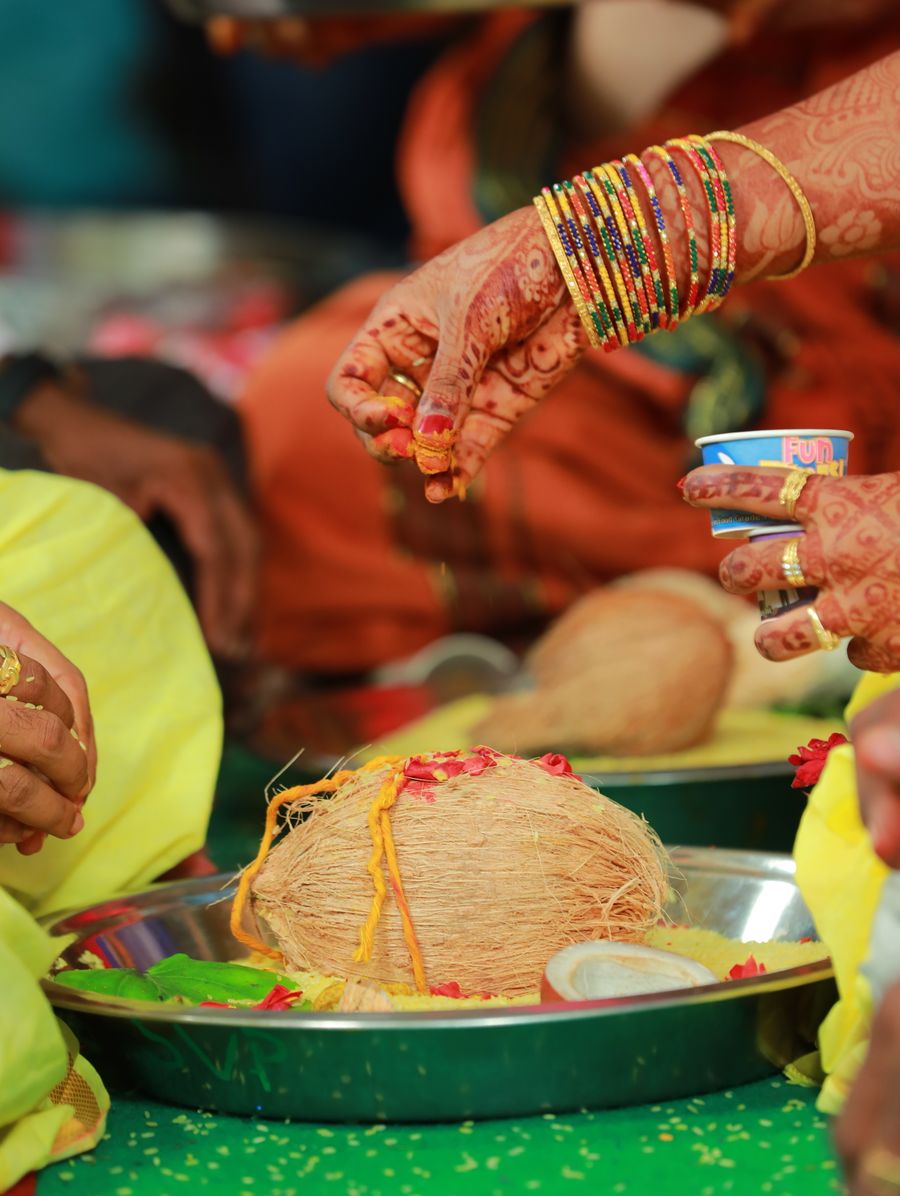 Henna-adorned bridal hands with traditional bangles