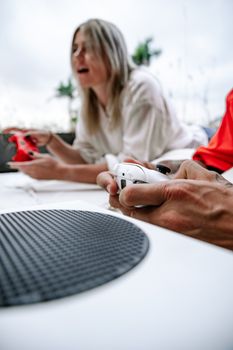 Dynamic shot of young adults intensely playing video games with controllers, focused and animated.