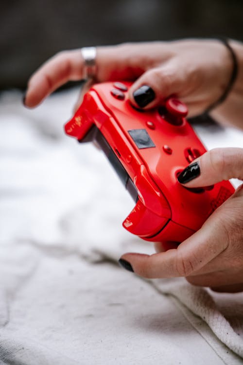 Person Holding Red Game Controller