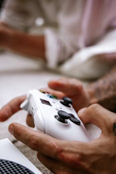 Close-up of hands holding a video game controller, focusing on gaming details.
