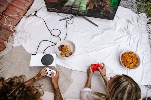 Top View of a Couple Playing on a Game Console Together