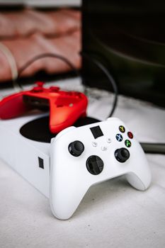 Close-up of red and white gaming console controllers on display, perfect for tech enthusiasts.