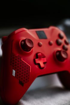 Detailed shot of a red wireless game controller with geometric design.