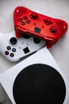 Vertical shot of vibrant red and white game controllers on a modern console.