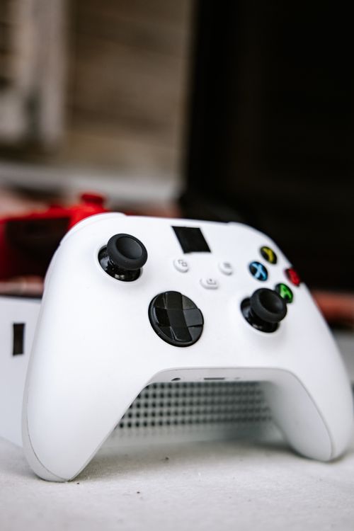 Free Detailed vertical shot of a white gaming controller highlighting modern design and controls. Stock Photo