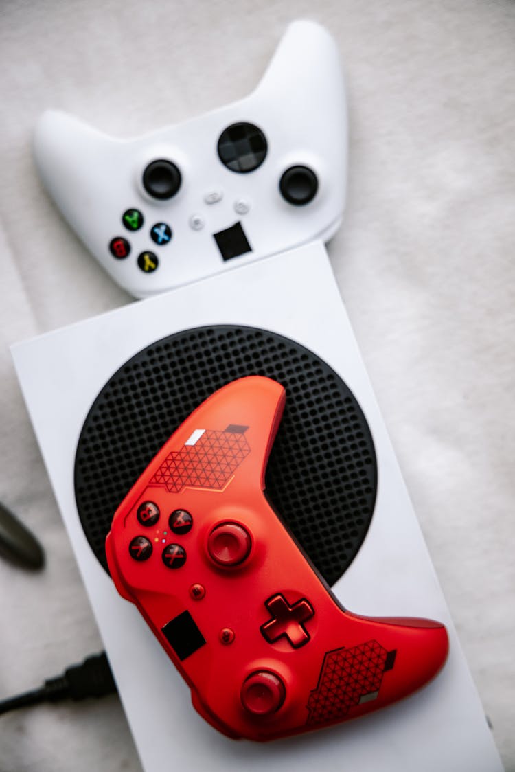 Red And White  Xbox Wireless Controllers In Close Up Photography