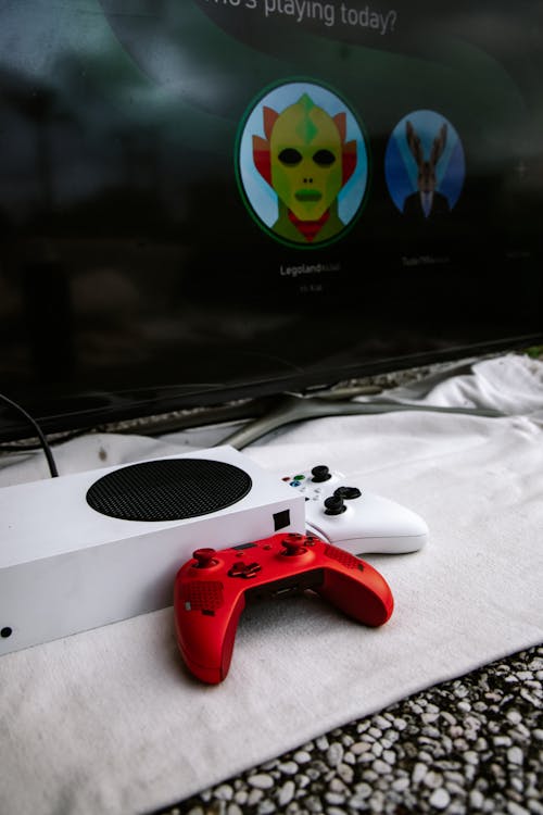 Close-Up Shot of White and Red Game Controllers