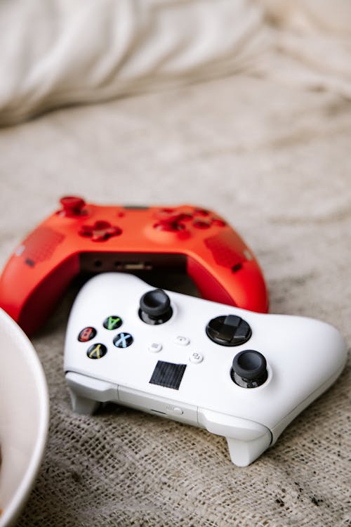 Close-Up Shot of White and Red Game Controllers