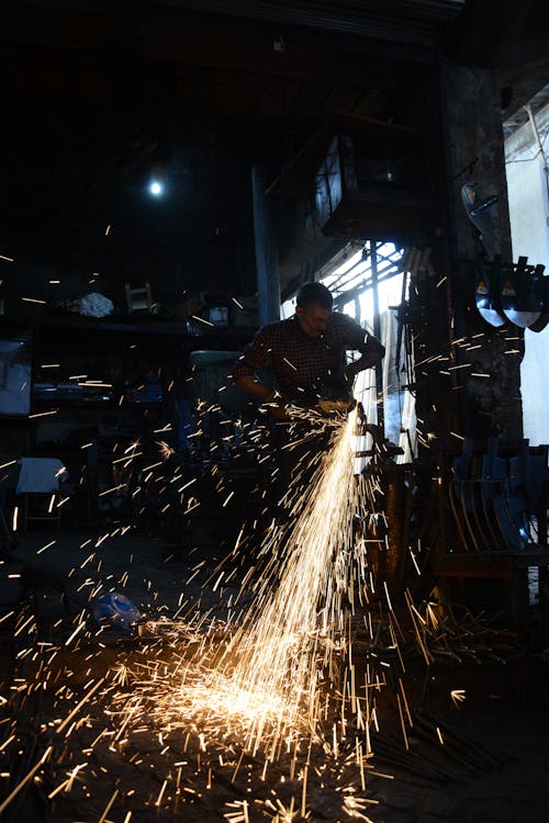 A Man Grinding a Metal