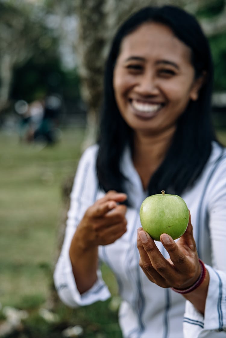 A Woman Holding An Apple