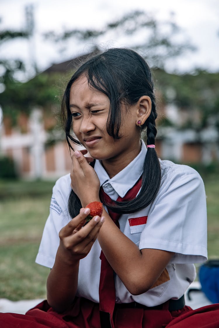 A Girl Holding A Fruit