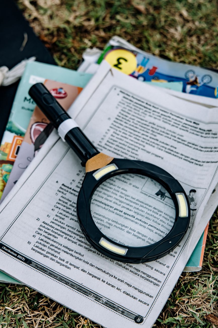 Magnifying glass resting on a printed legal document on a desk
