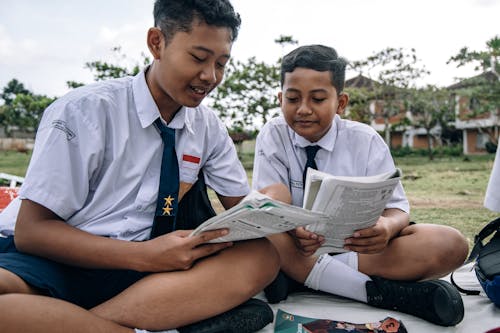 Boys in School Uniforms Reading Books