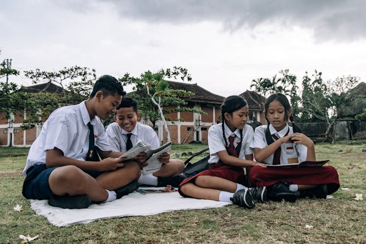 Boys And Girls In School Uniforms At Picnic