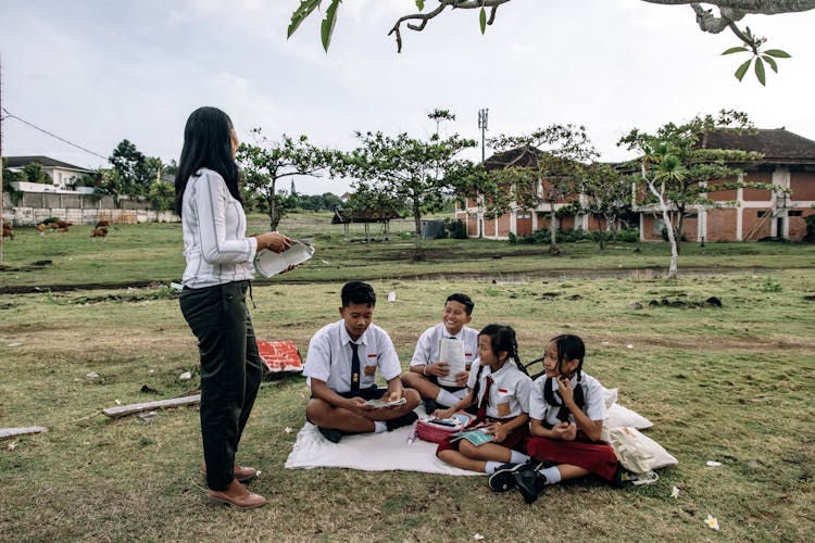 Teacher With Students Outdoors 