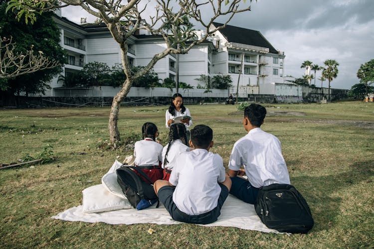 A Group Of Students Reading Books