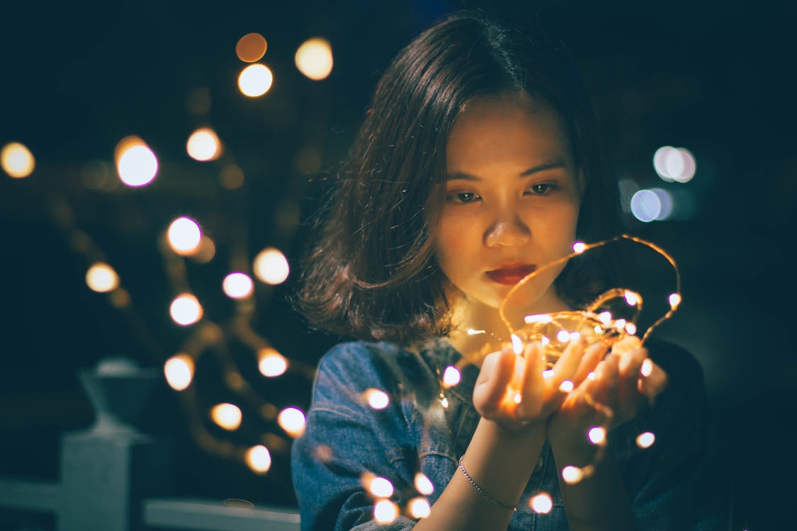Free Close-Up Photography of Woman Holding Sting Lights Stock Photo