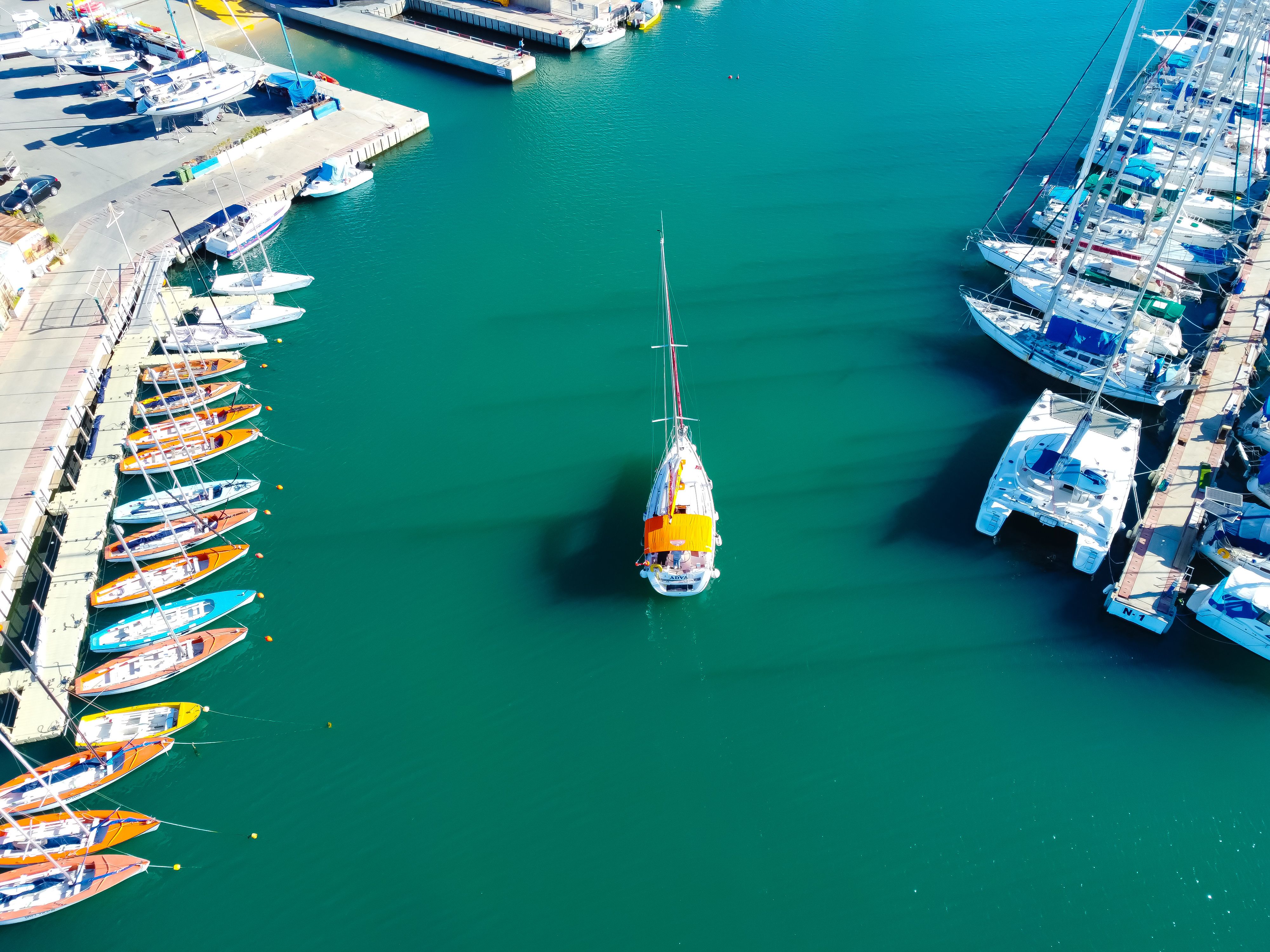 Spectacular Private Catamaran Adventure Cruise with Rope Swing and Water Slide Review 2026 - Drone shot of yachts docked at Ashdod Marina, Israel, showcasing vibrant water and boats.