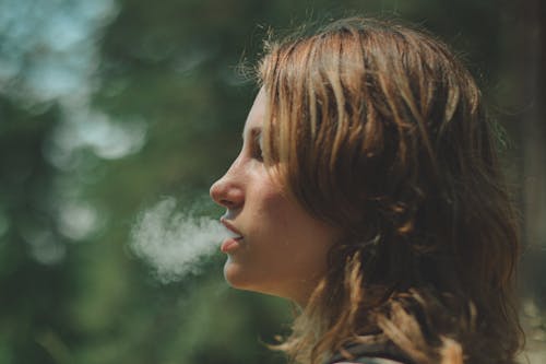 A Side View of a Woman Smoking