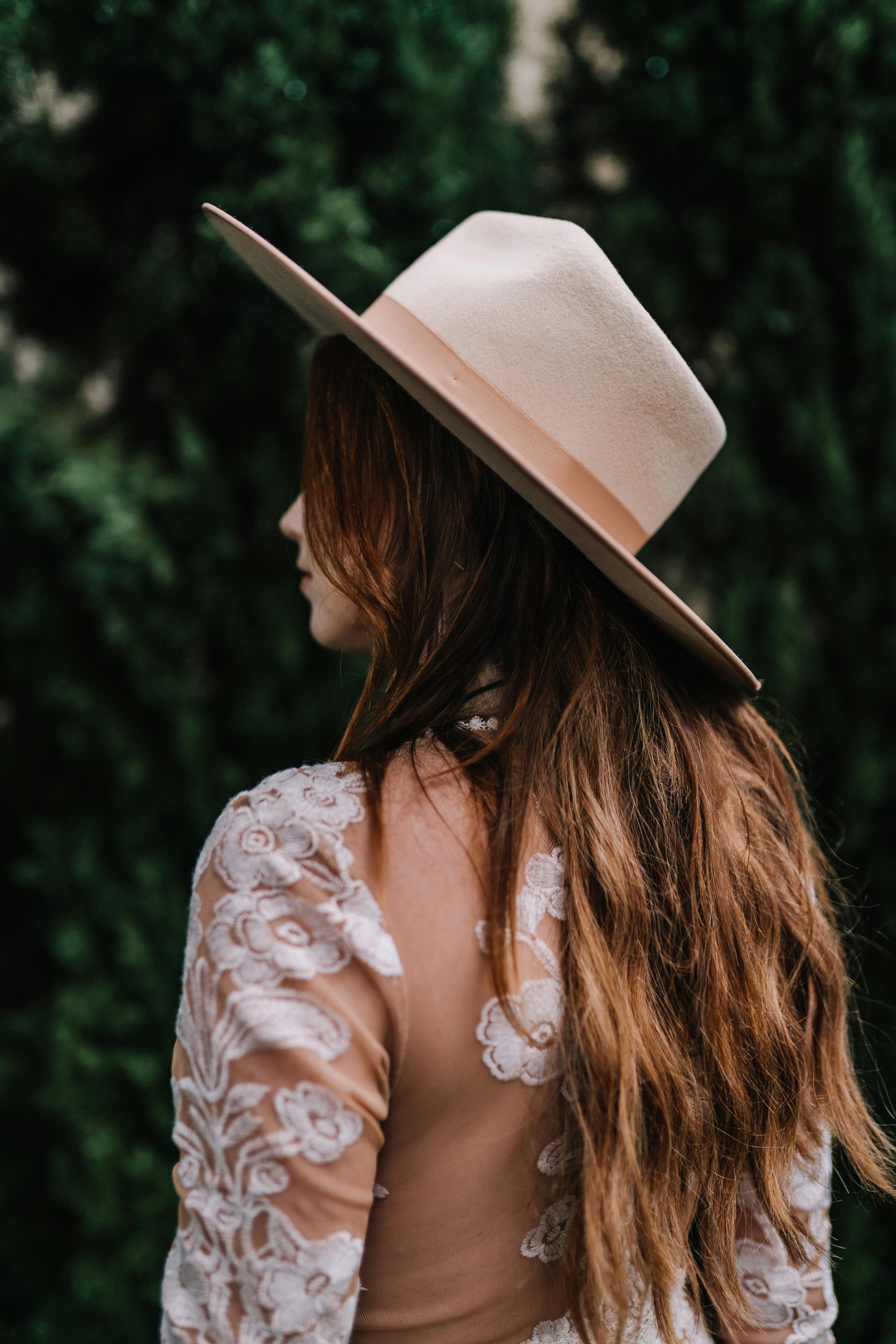 A Woman in Floral Top Wearing a Wide Brim Hat · Free Stock Photo