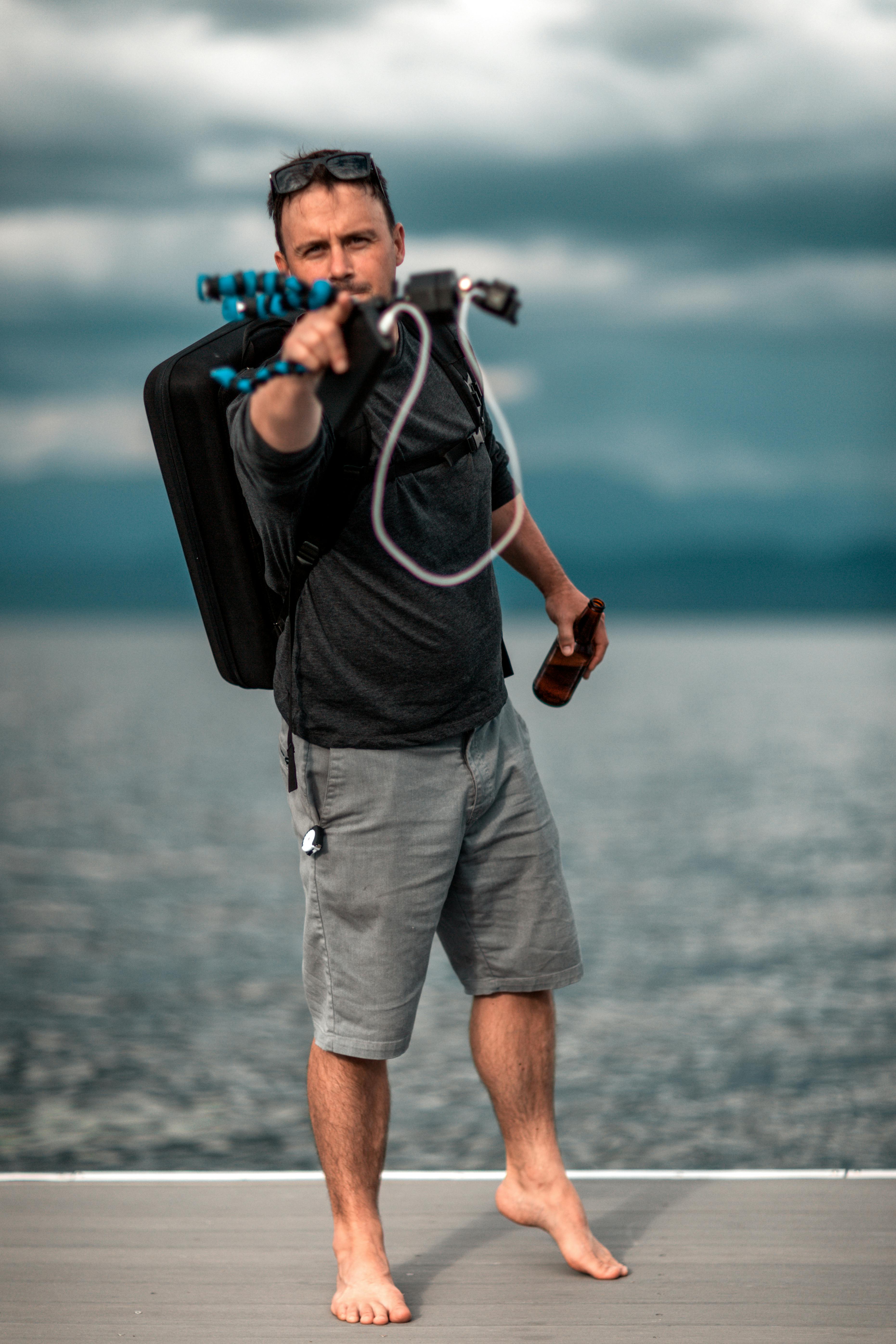 man with a bottle of beer varying a backpack