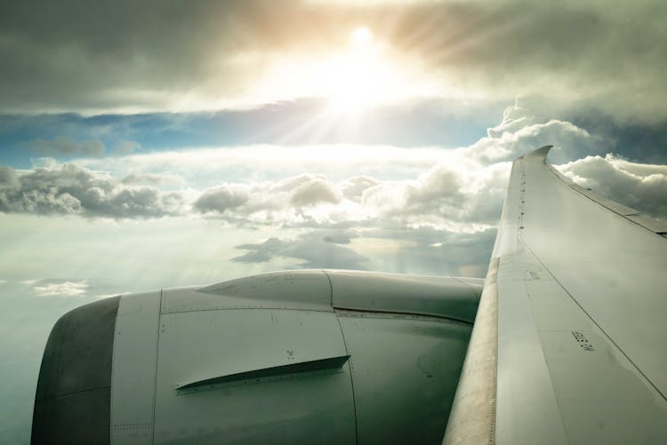 Airplane Wing And Clouds View From An Airplane Window 