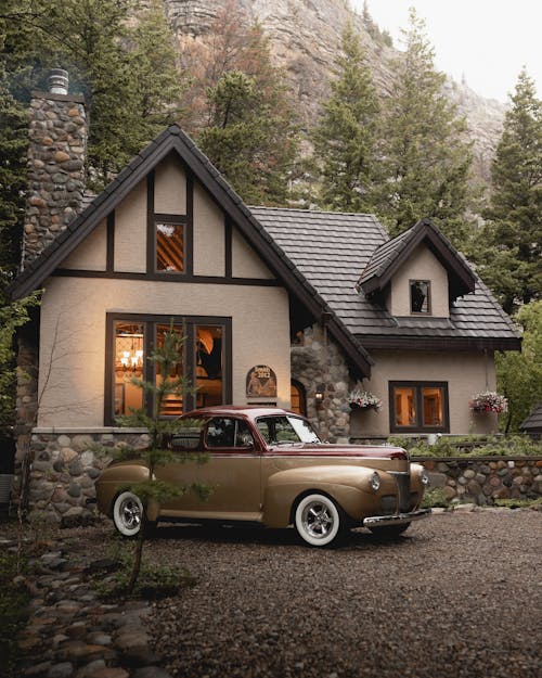 A Vintage Car Parked in Front of the House