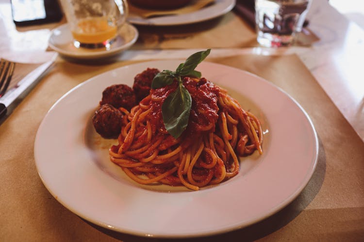 A Spaghetti With Meatballs On A Ceramic Plate