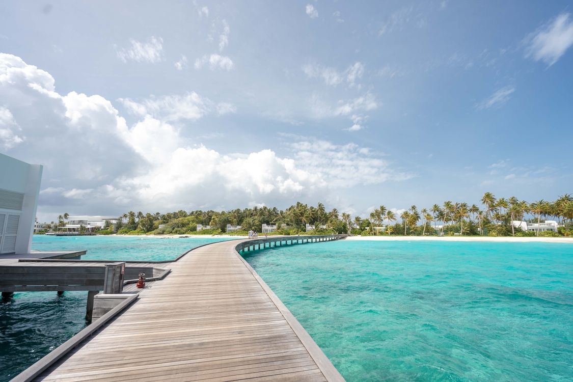 Brown Wooden Dock on Blue Sea Under Cloudy Sky · Free Stock Photo
