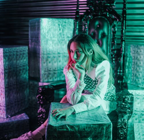 A Woman Wearing White Long Sleeves Sitting on the Chair 