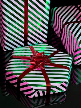 Striped gift boxes with red ribbons, perfect for holiday celebrations and festive occasions.