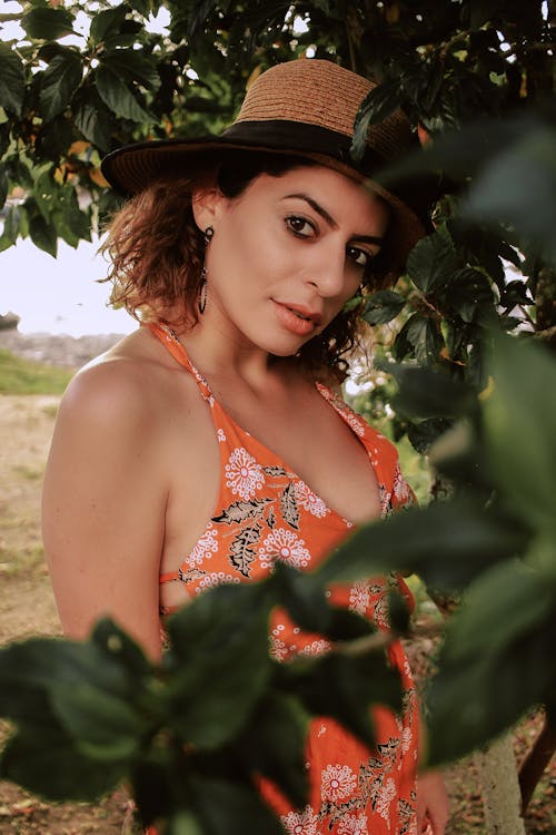 Woman Wearing Orange, Black, and White Floral Halter-neck Top