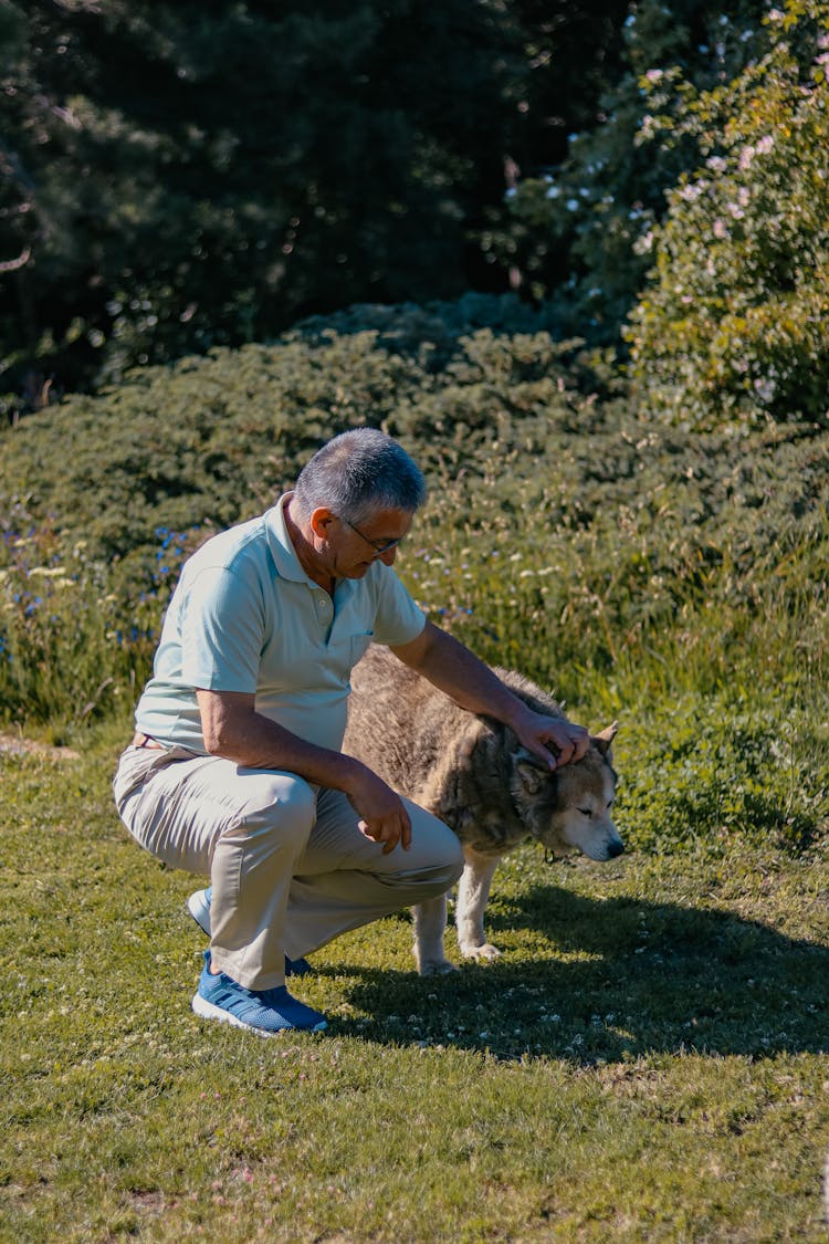 A Man Holding A Dog 