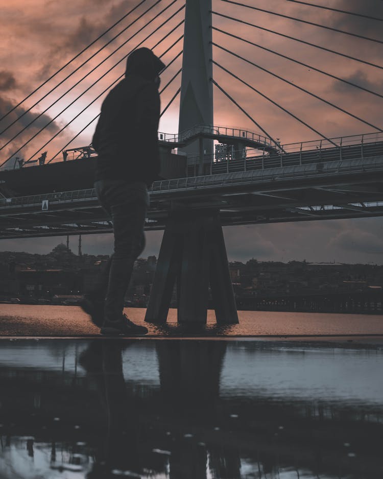 Man Walking By The Golden Horn Bridge At Sunset 