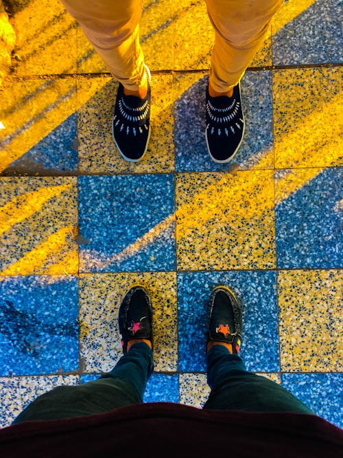 Two Person Wearing Loafers on Tiles