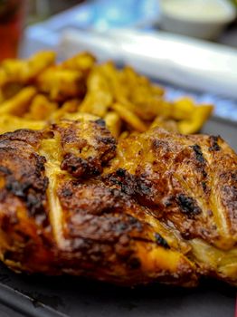Delicious close-up of grilled chicken with fries, capturing the flavors in Montpellier, France.