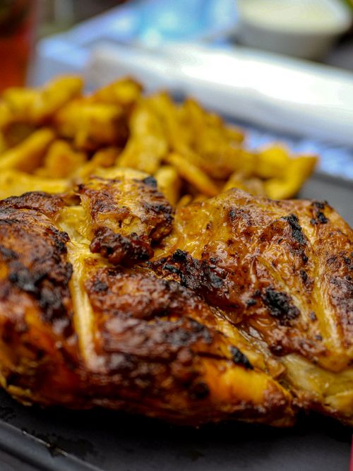 Free Delicious close-up of grilled chicken with fries, capturing the flavors in Montpellier, France. Stock Photo