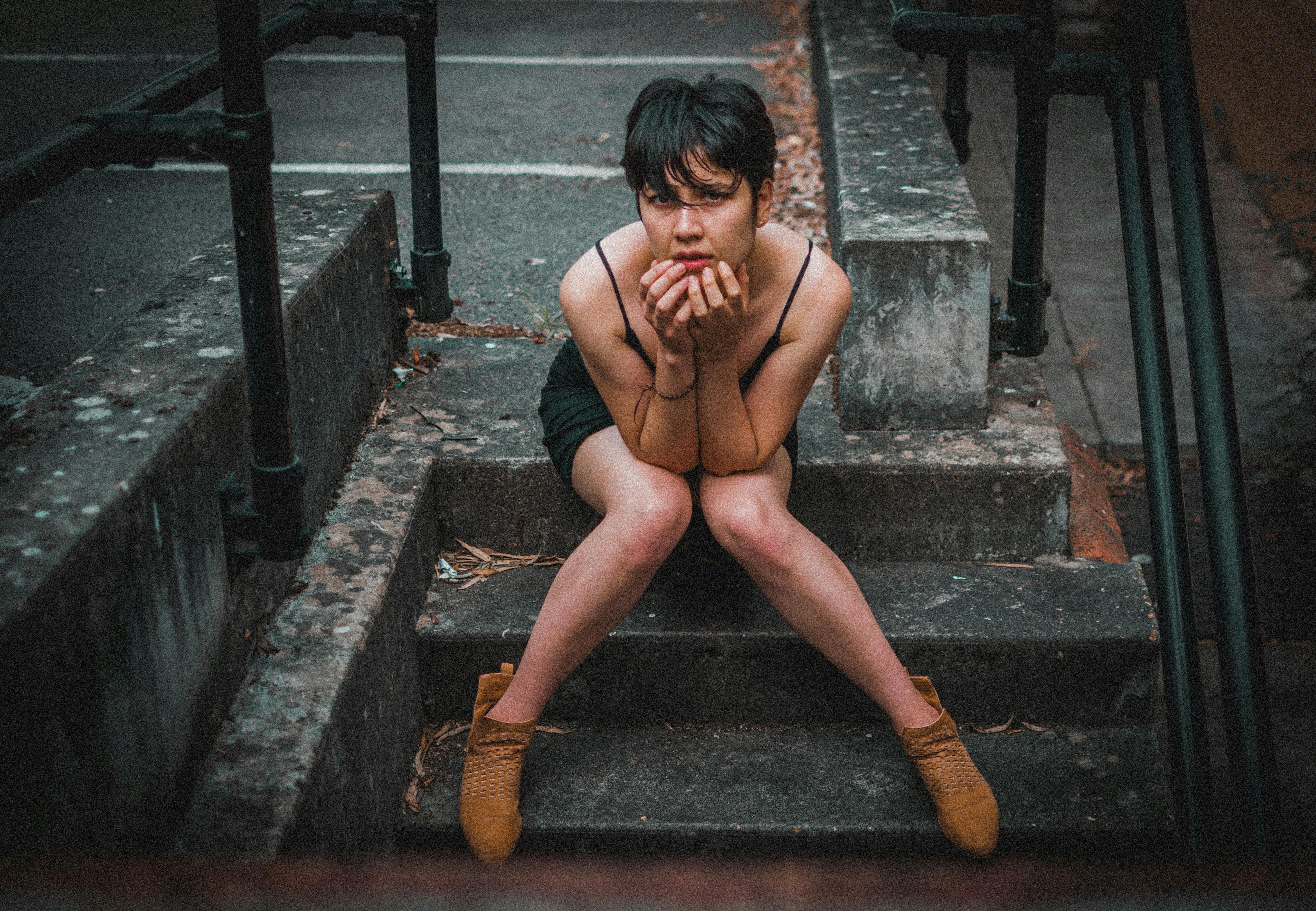 Woman Sitting on Concrete Stairs